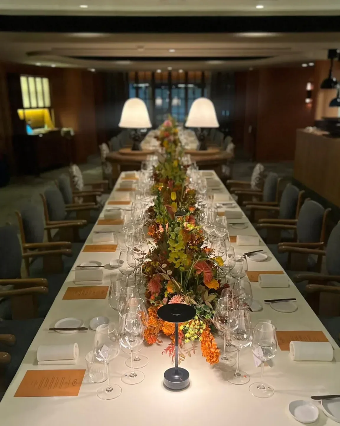 Elegant dining table setting at Estro, a restaurant in Hong Kong, with floral centerpiece