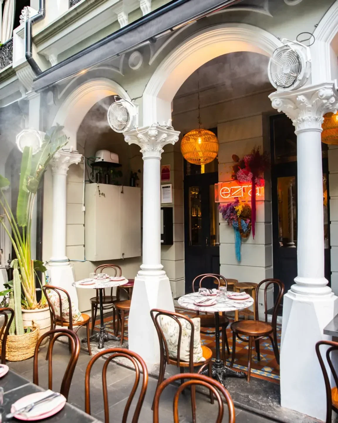 Outdoor dining at Ezra restaurant in Sydney, featuring stylish decor and intimate seating.