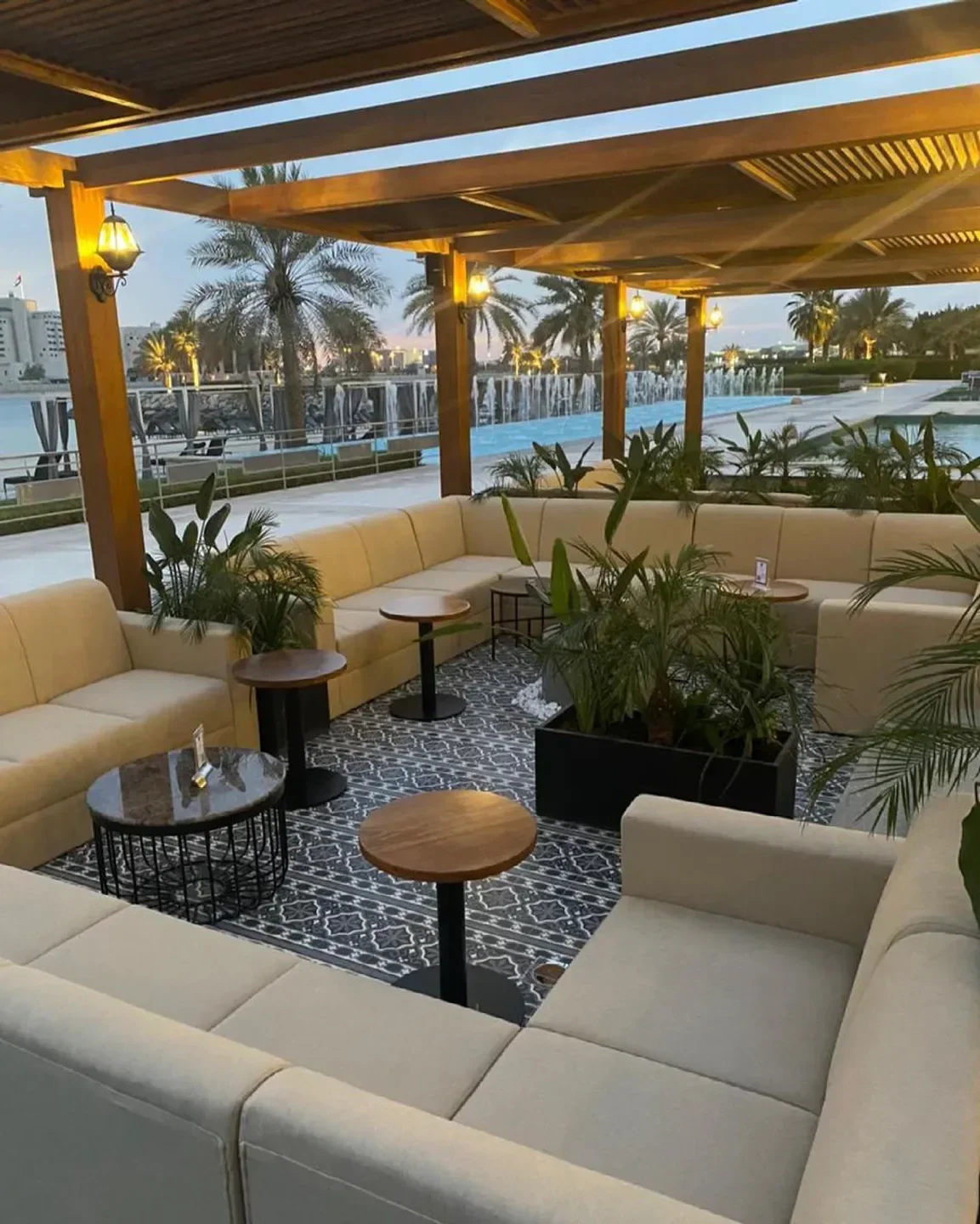 Outdoor seating area at Fairmont Bab Al Bahr in Abu Dhabi, beach club setting with water views