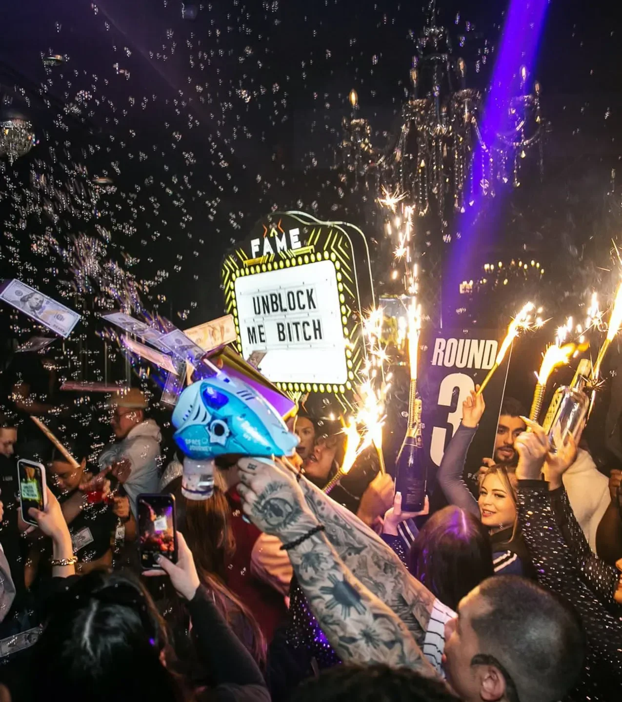 Nightclub scene at Fame Chicago, featuring confetti, champagne and crowd celebration.