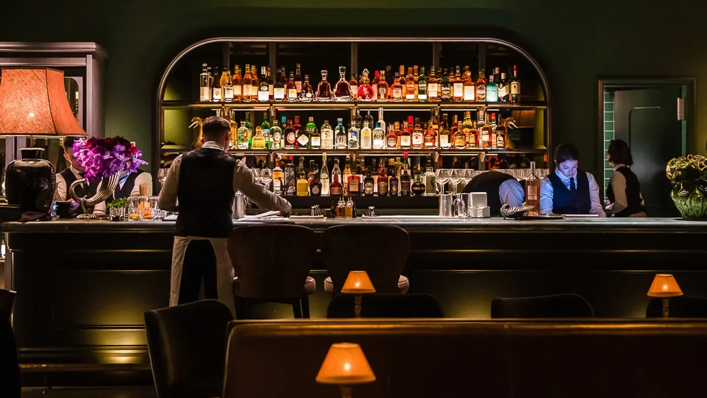 Classic bar scene at Felix in Sydney, showcasing a well-stocked liquor selection and staff.