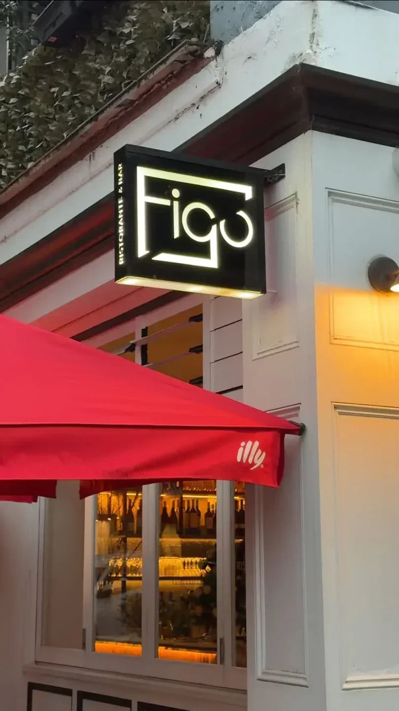 Exterior of FIGO Restaurant & Bar in Sydney with red awning and illuminated sign