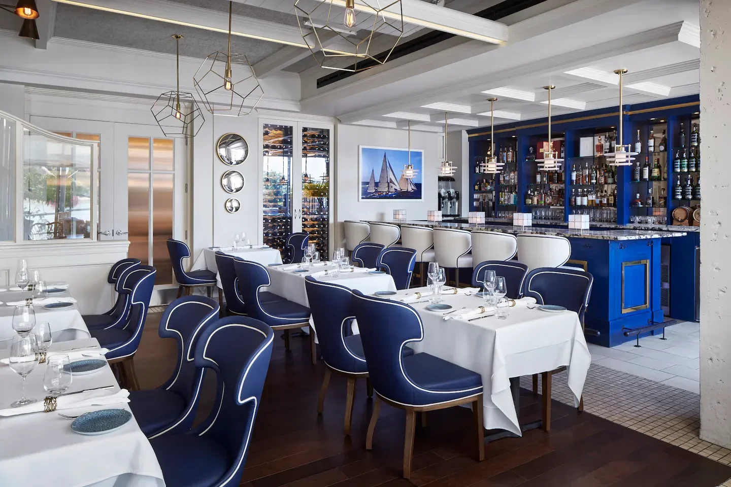 Fiola Mare in Washington: Elegant dining room with blue chairs and a nautical bar.