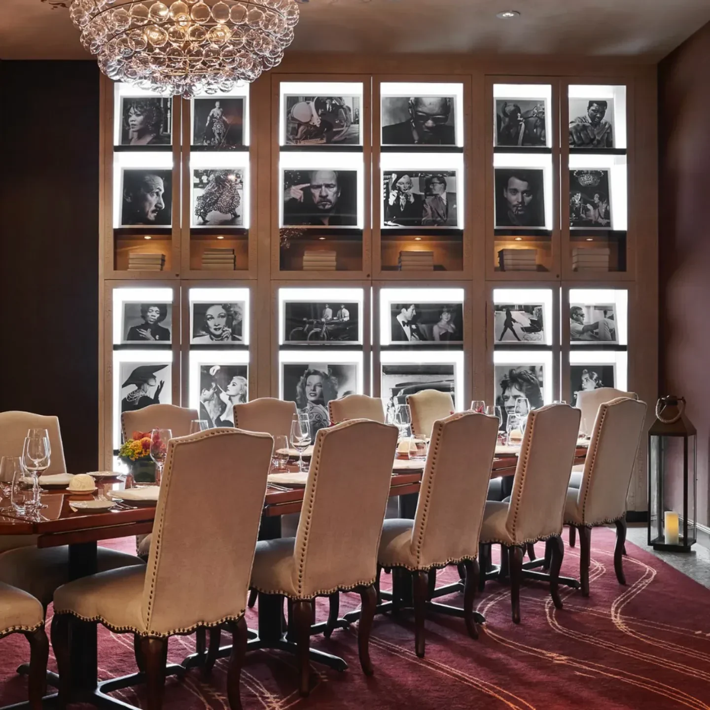 Fiola restaurant interior in Washington, featuring dining table and celebrity portraits.