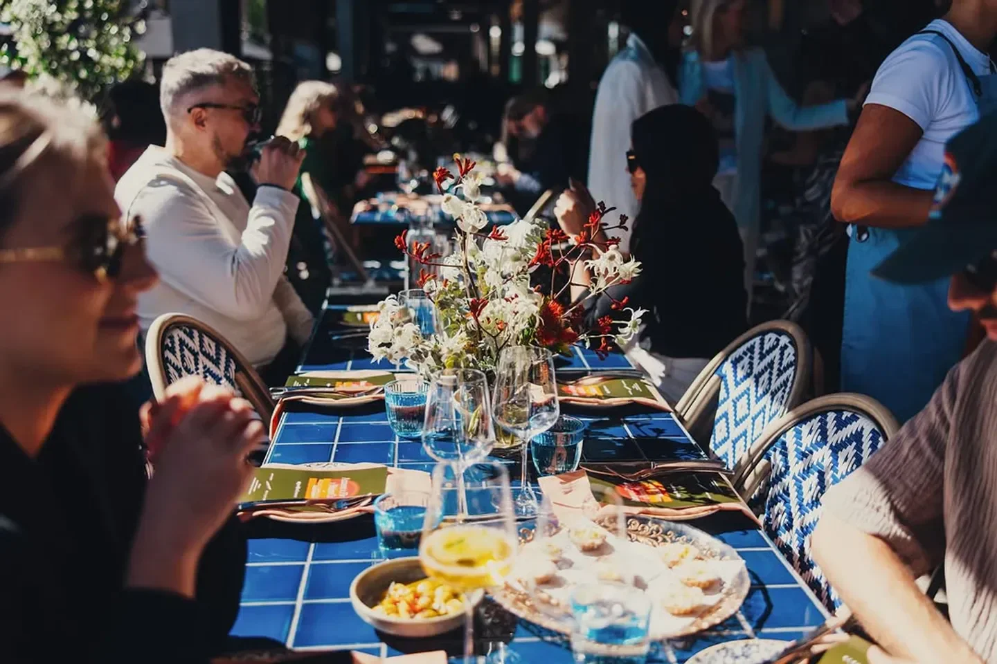Dining scene at Firepop restaurant in Sydney with floral centerpiece and patrons