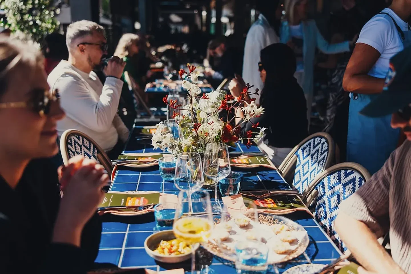 Dining scene at Firepop restaurant in Sydney with floral centerpiece and patrons