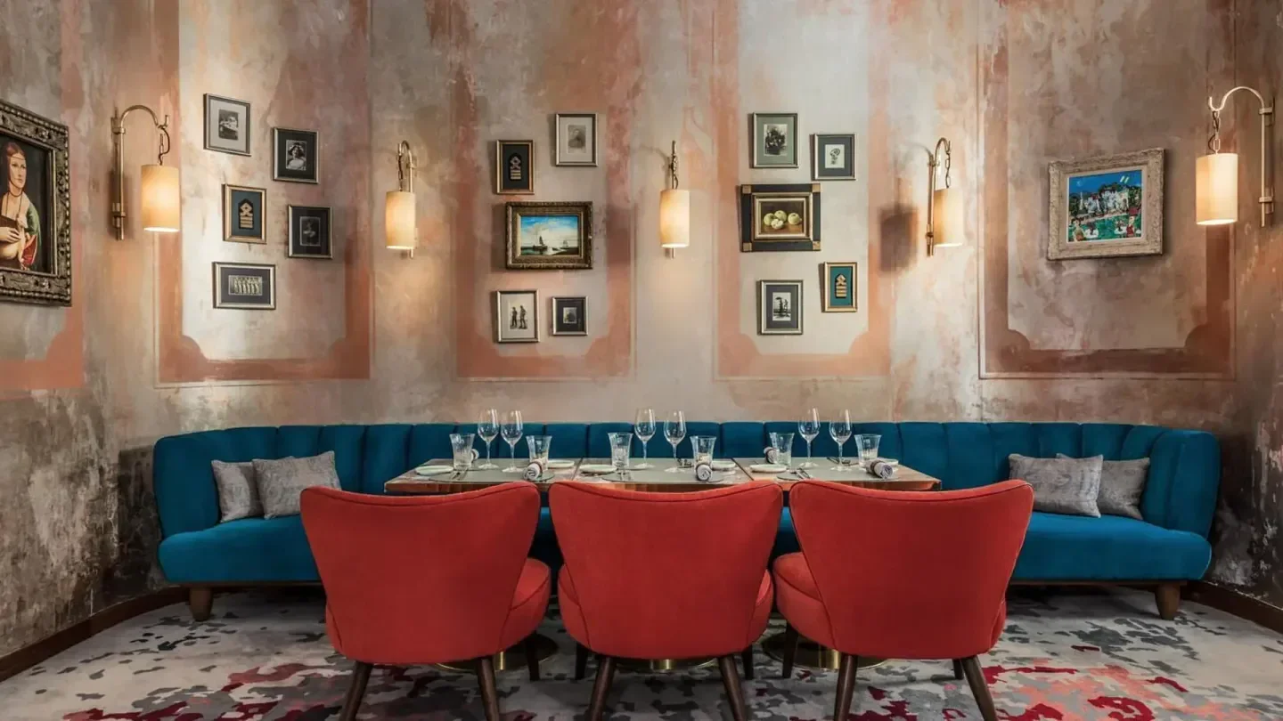 Elegant dining area at Fiskebar in Geneva with red chairs and vintage artwork.