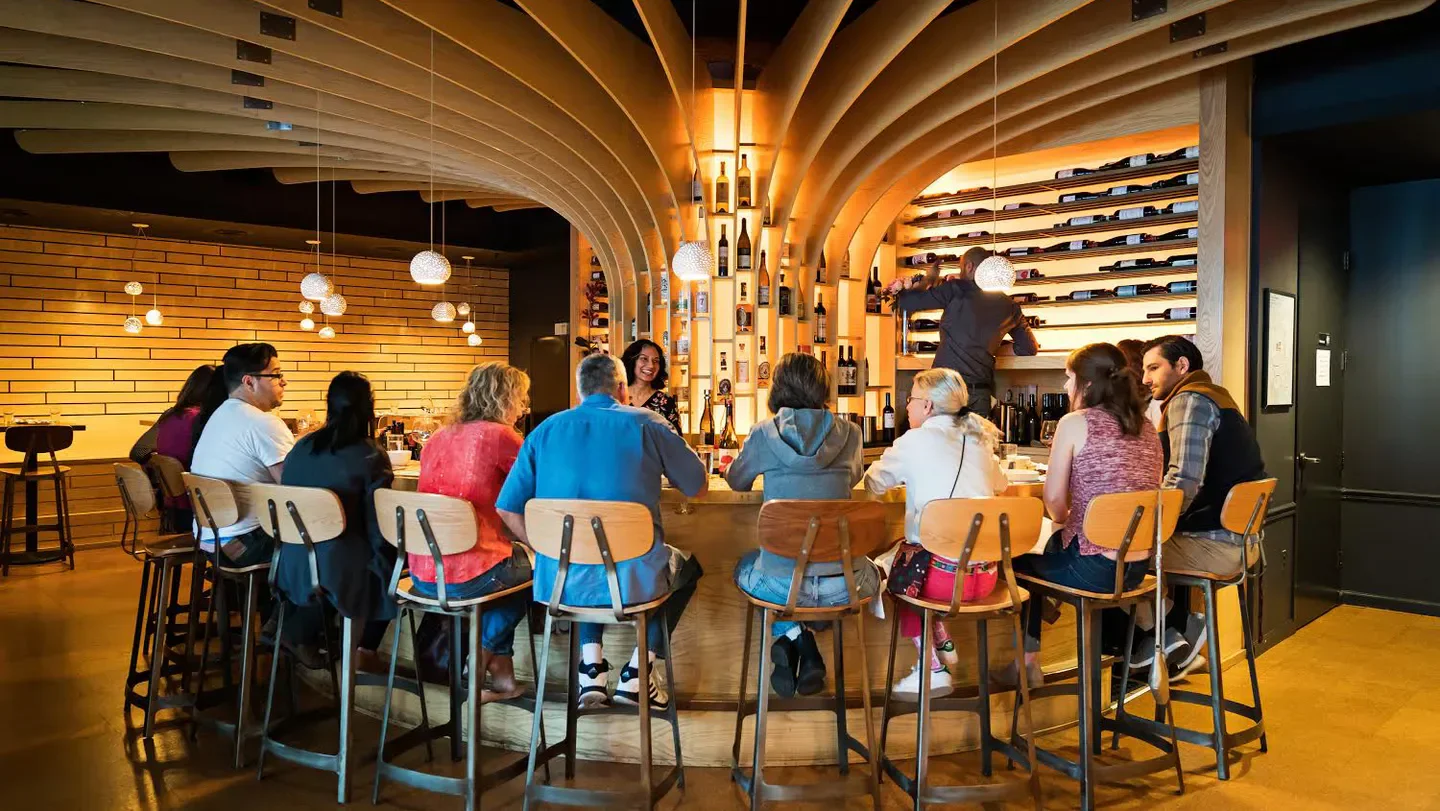 Interior of Flight Wine Bar in Washington, people enjoying the bar and wine selection.