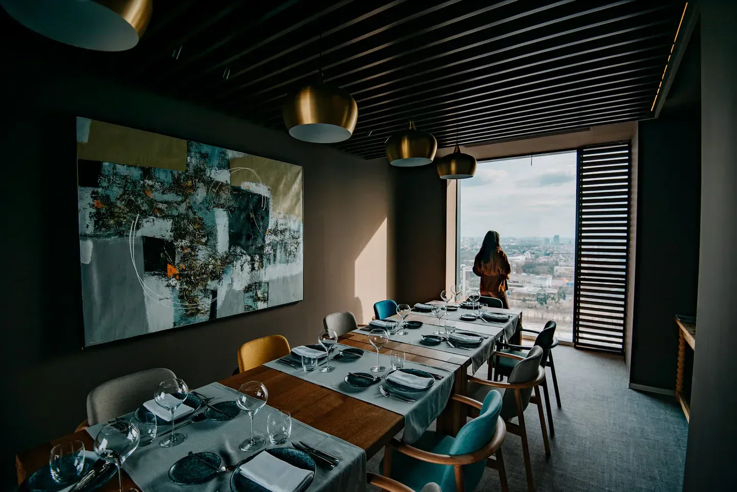 Fork Ana Tower restaurant interior, Bucharest, with city view from large windows.