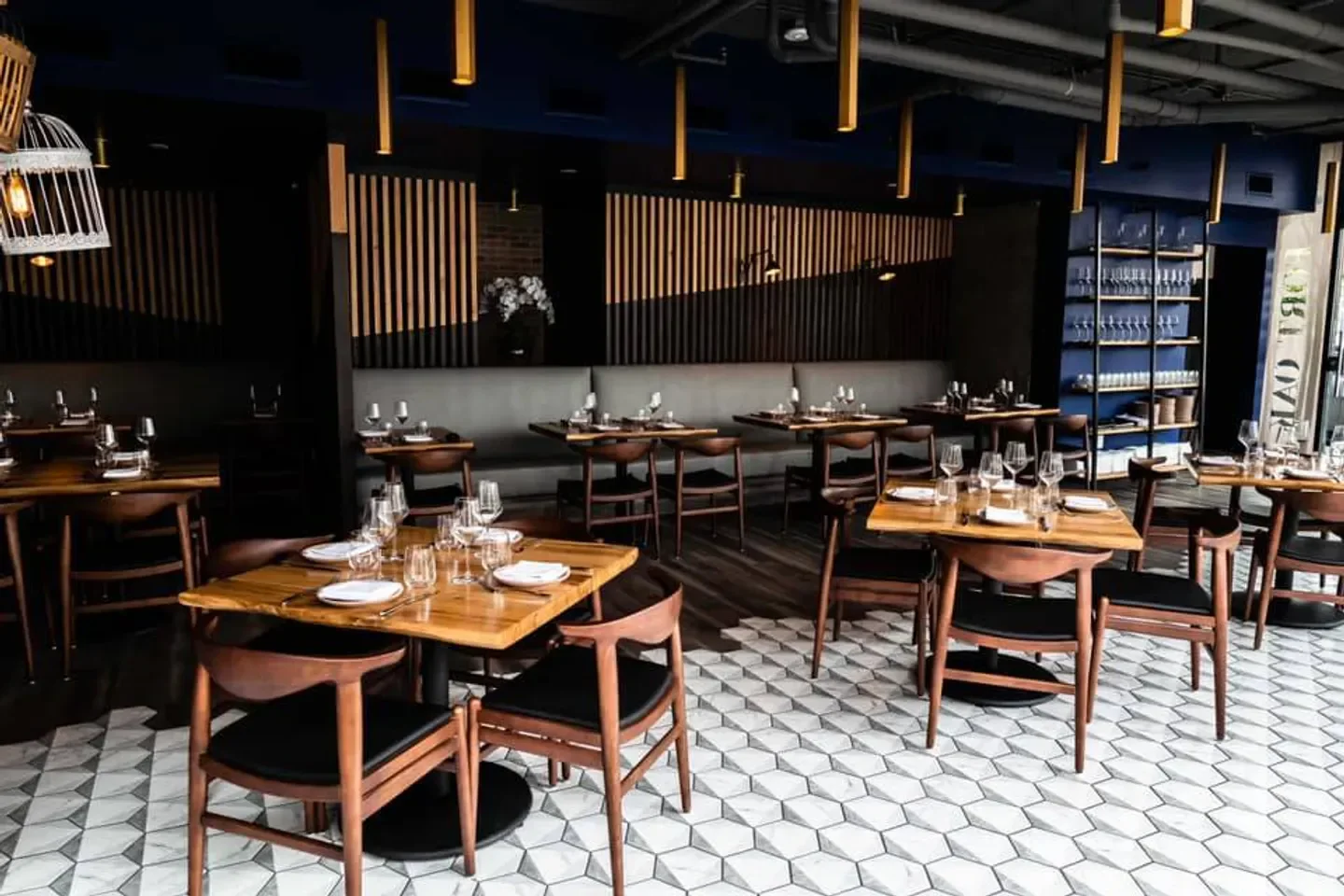 Elegant dining area at Fort Oak restaurant in San Diego, with wood tables and stylish chairs.