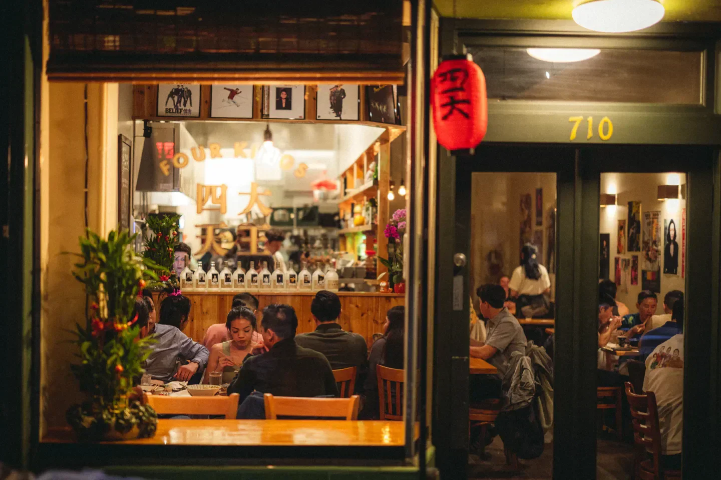 Cozy restaurant interior at Four Kings in San Francisco, with patrons dining.