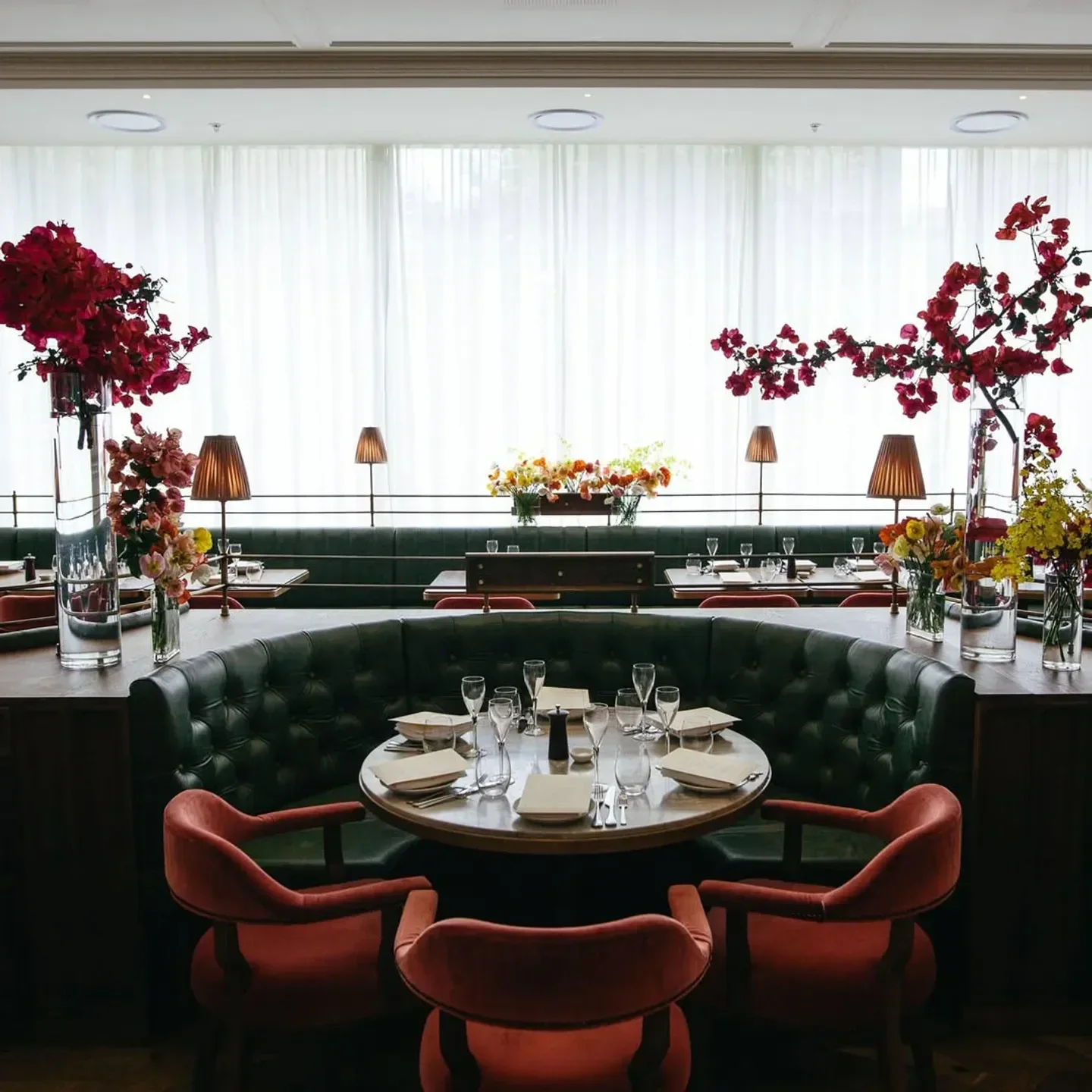 Elegant dining room interior at Franca Brasserie in Sydney with floral decorations and table settings.