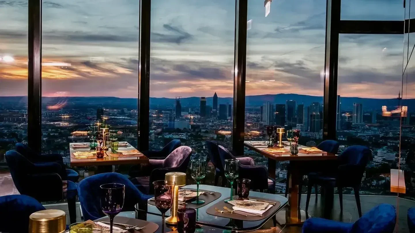 Franziska Restaurant in Frankfurt: Fine dining with panoramic city views at sunset.