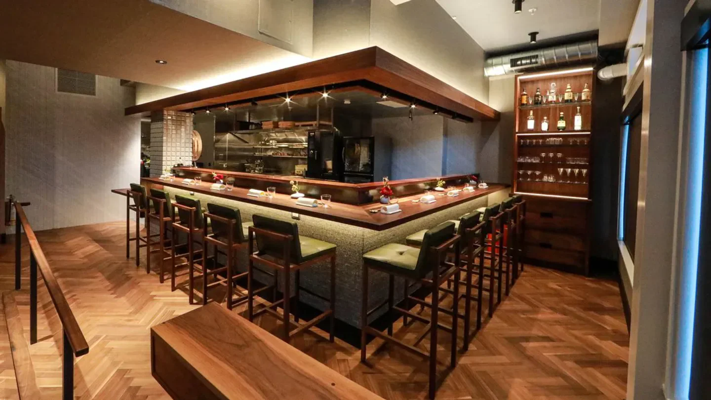 Interior of Friends Only restaurant in San Francisco with bar seating and kitchen view