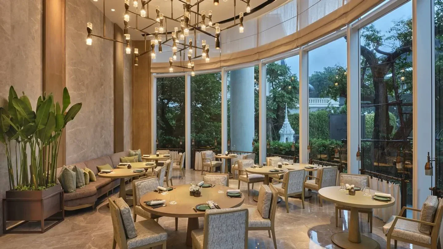 Elegant interior of Front Room restaurant in Bangkok, featuring stylish decor and large windows.