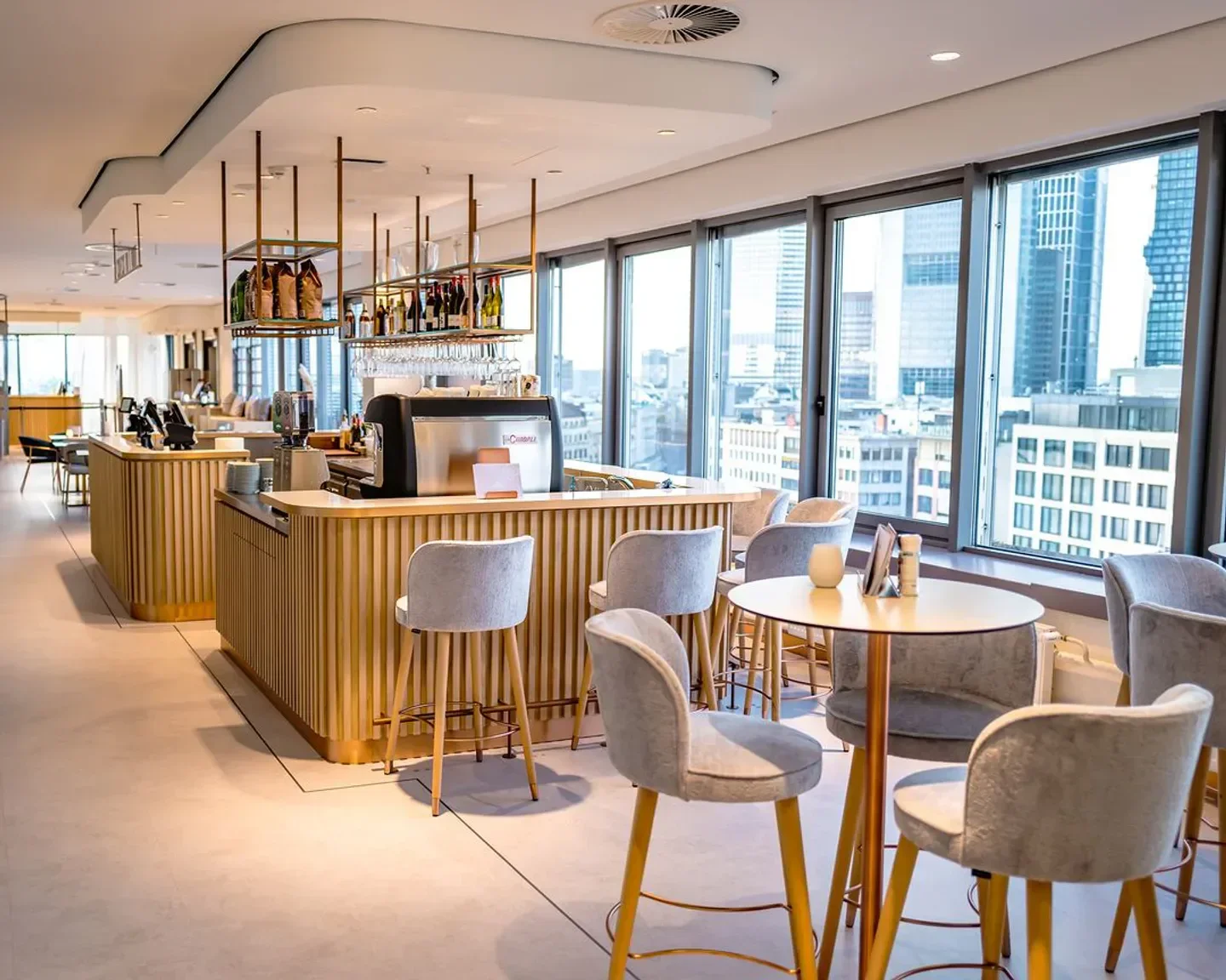 Modern interior of Galeria Kaufhof Restaurant in Frankfurt with a bar and city views.