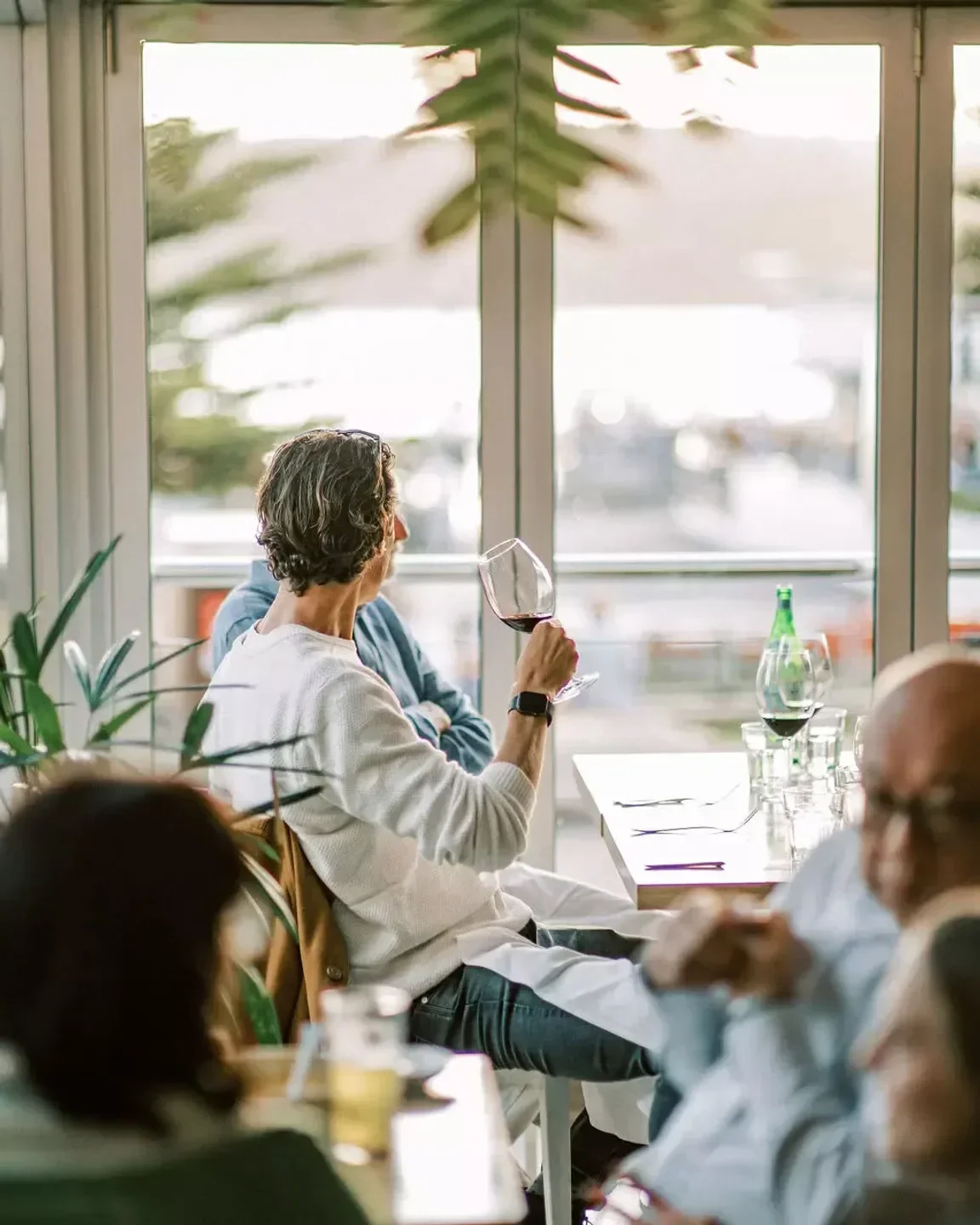 Dining at Garfish Manly restaurant in Sydney, enjoying wine and a waterfront view.
