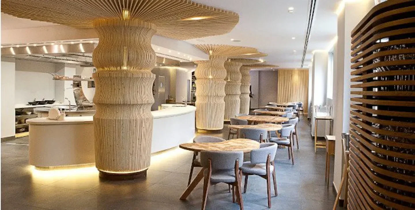 Interior of Gaytán restaurant in Madrid, featuring unique pillar design and dining tables.