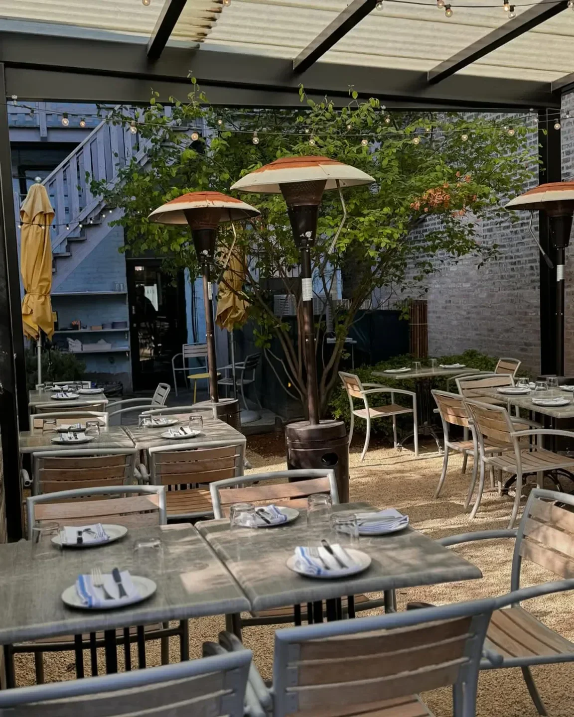 Outdoor dining area at Giant restaurant in Chicago with heaters and tables set