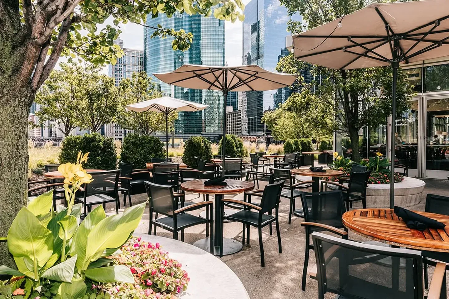 Outdoor dining at Gibsons Italia in Chicago with city views, tables, and umbrellas.