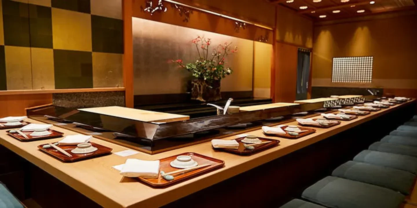 Interior of Ginza Kyubey restaurant in Tokyo, showcasing elegant sushi counter setting.