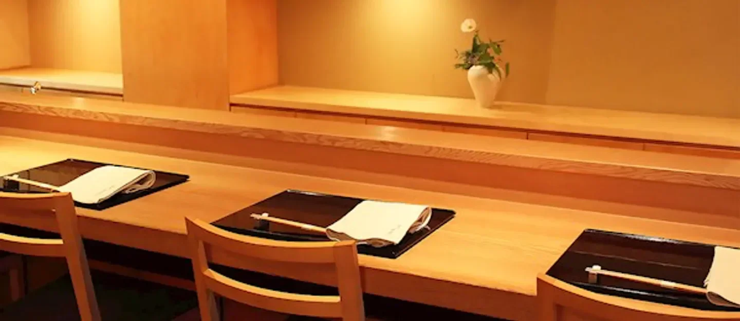 Cozy dining area at Ginza Toyoda restaurant in Tokyo, showcasing elegant wood design.