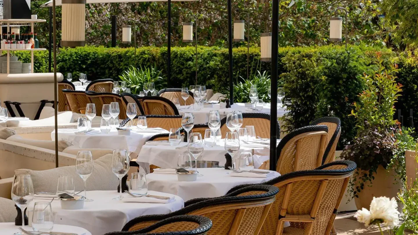 Outdoor dining at Girafe restaurant in Paris, with tables set for guests.