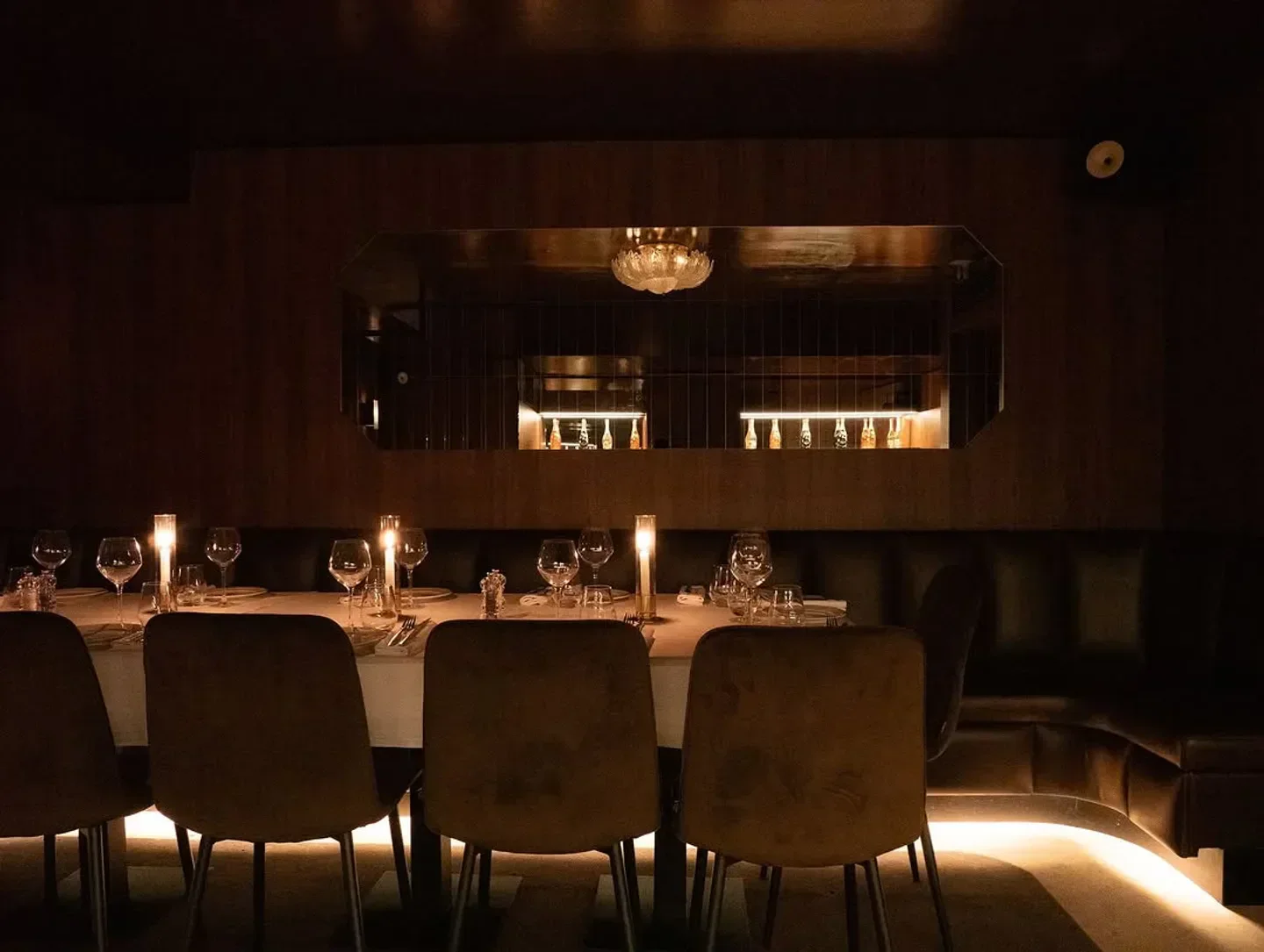 Cozy dining area at Giulia Club, Paris, featuring candles and elegant table setting