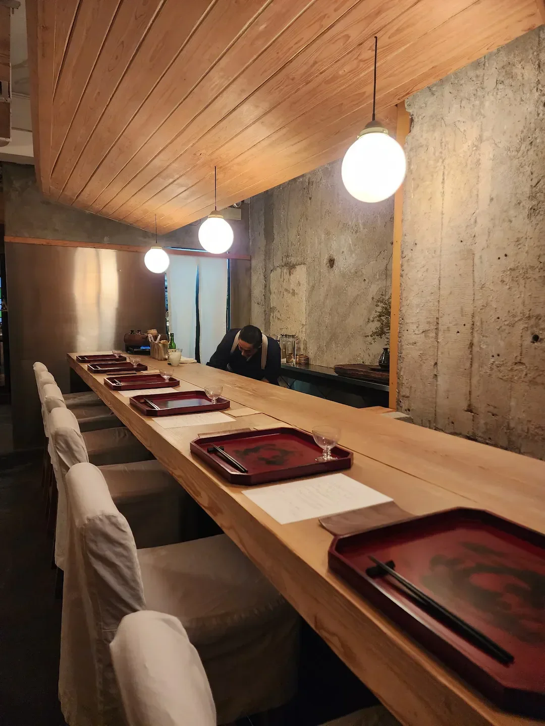 Elegant dining at Godenya restaurant in Hong Kong with a sleek interior and lighting.