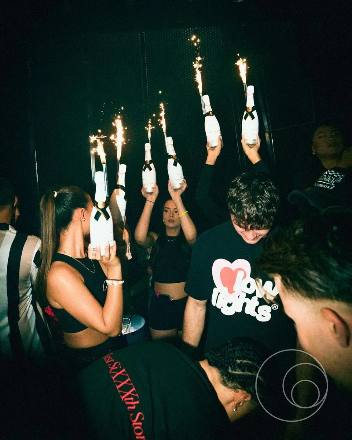 Golden Cut nightclub in Hamburg celebration with champagne bottles and sparklers.