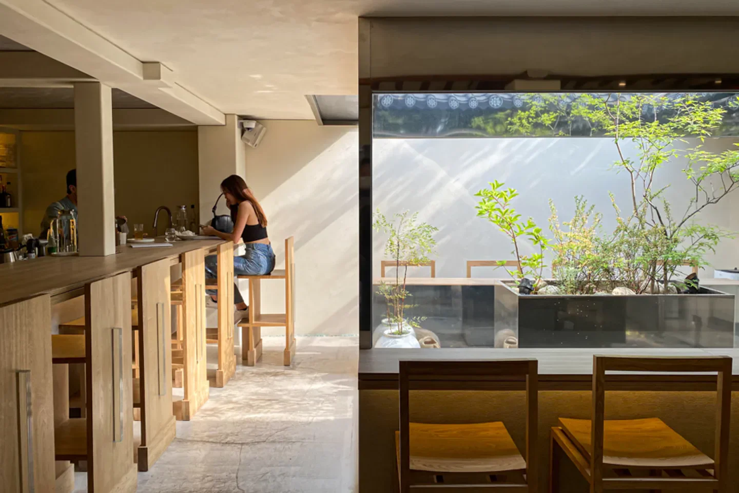 Interior of Gong-Gan restaurant in Seoul. Stylish design with a seated patron enjoying the space.