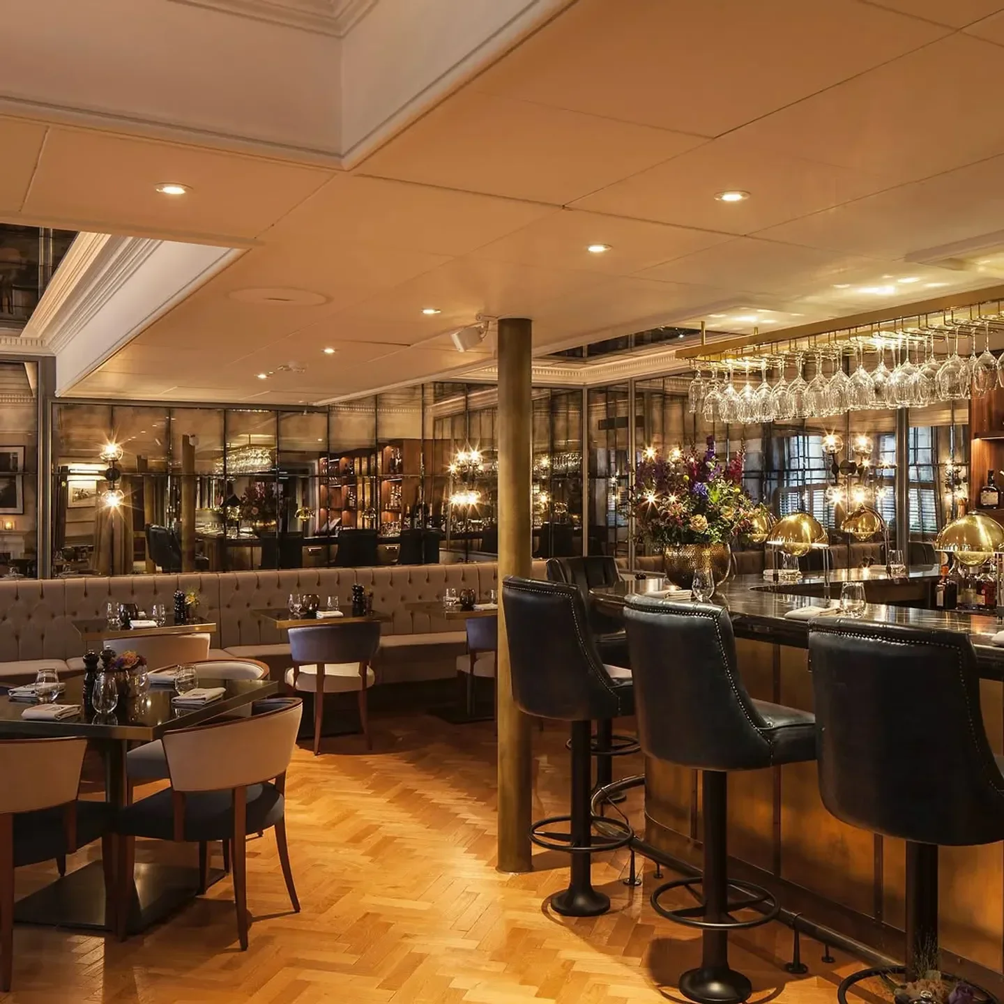 Interior of Great British Restaurant in London featuring bar seating and dining tables.