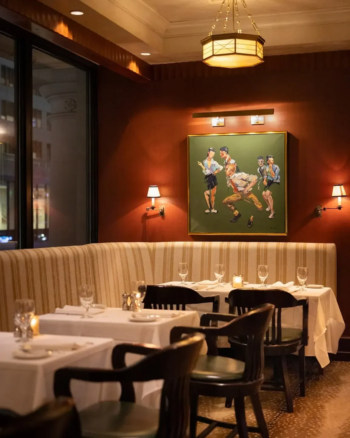 Cozy dining room at Grill 23 & Bar in Boston, featuring art and tables.