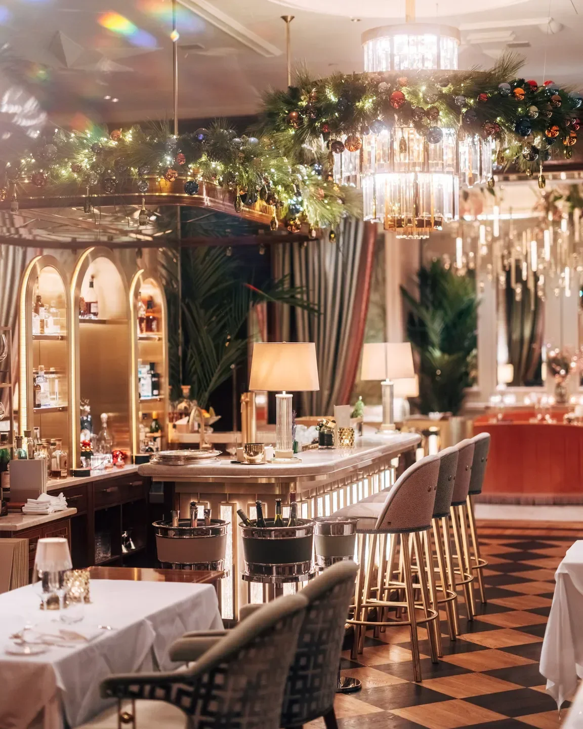 Elegant interior of GRILL restaurant in Hamburg, featuring bar and festive decorations.