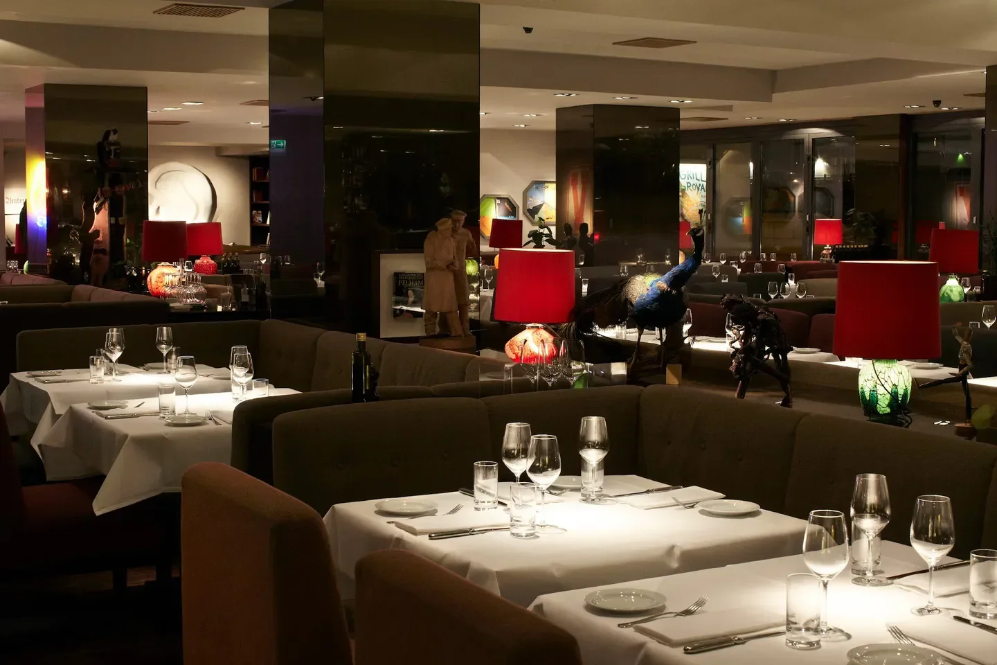 Grill Royal restaurant in Berlin with red lamps and peacock decor