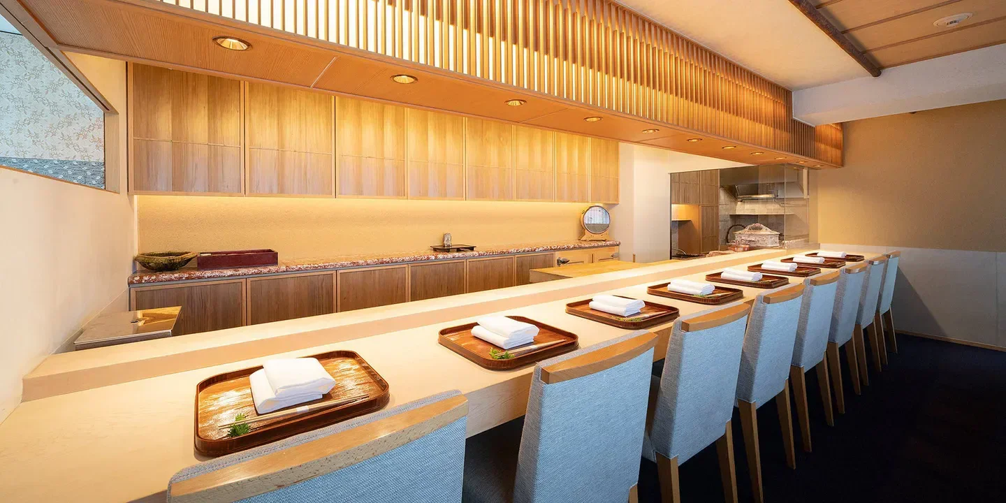 Interior view of Guchokuni restaurant in Tokyo, with elegant seating and wooden accents.