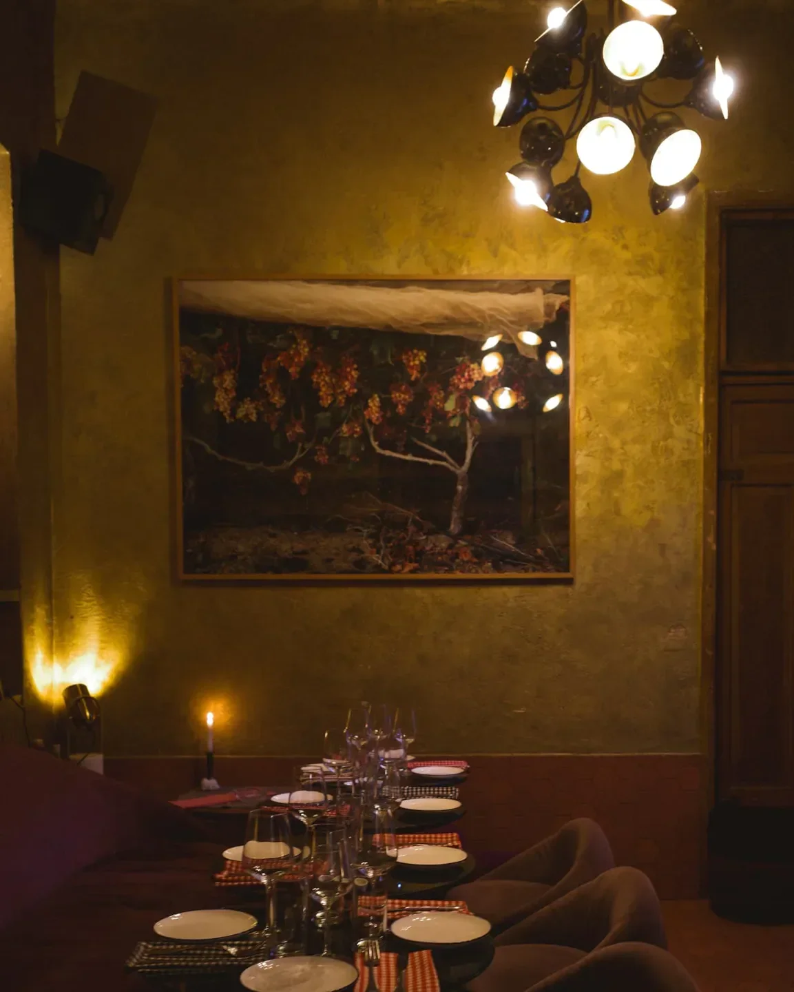 Elegant dining at HaBasta restaurant in Tel Aviv, with art and warm lighting.