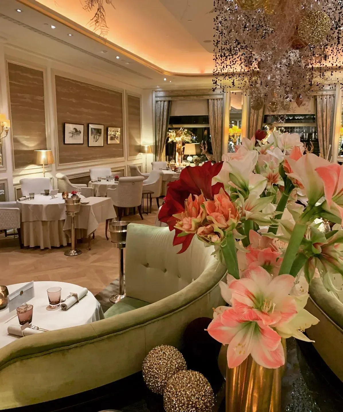 Elegant interior of Haerlin restaurant in Hamburg, featuring flowers and sophisticated decor.