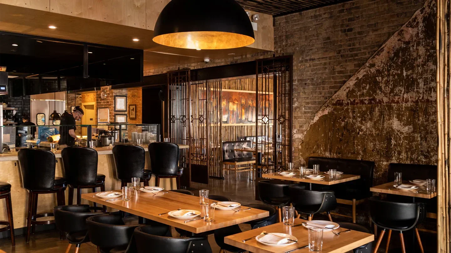 Elegant dining area inside HaiSous restaurant in Chicago with warm lighting and decor.