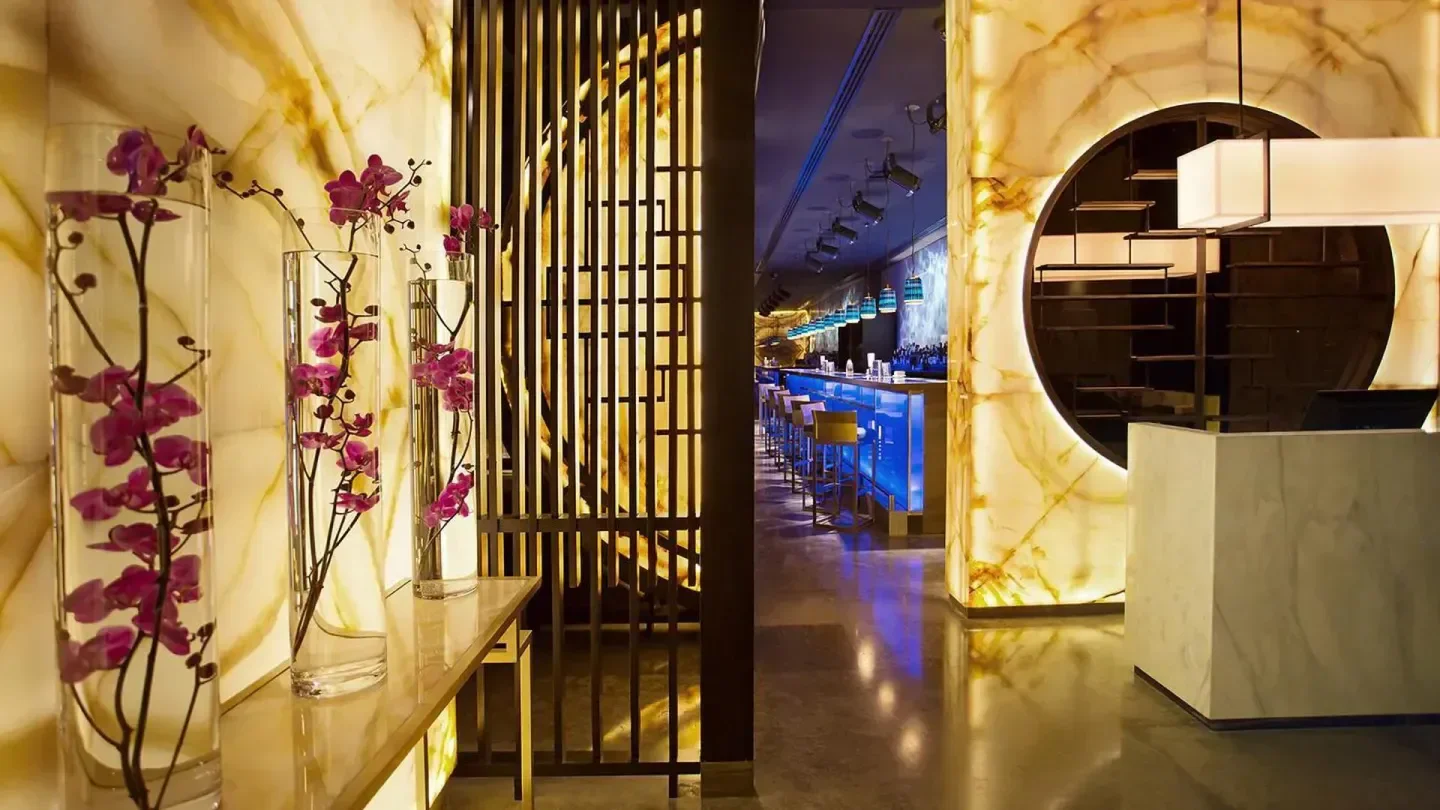 Interior view of Hakkasan Doha with orchids and stylish bar.