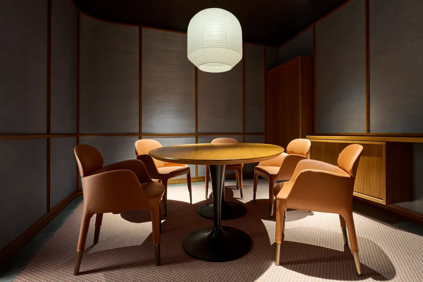 Cozy dining area at Hamamoto restaurant in Singapore, featuring round table and chairs.