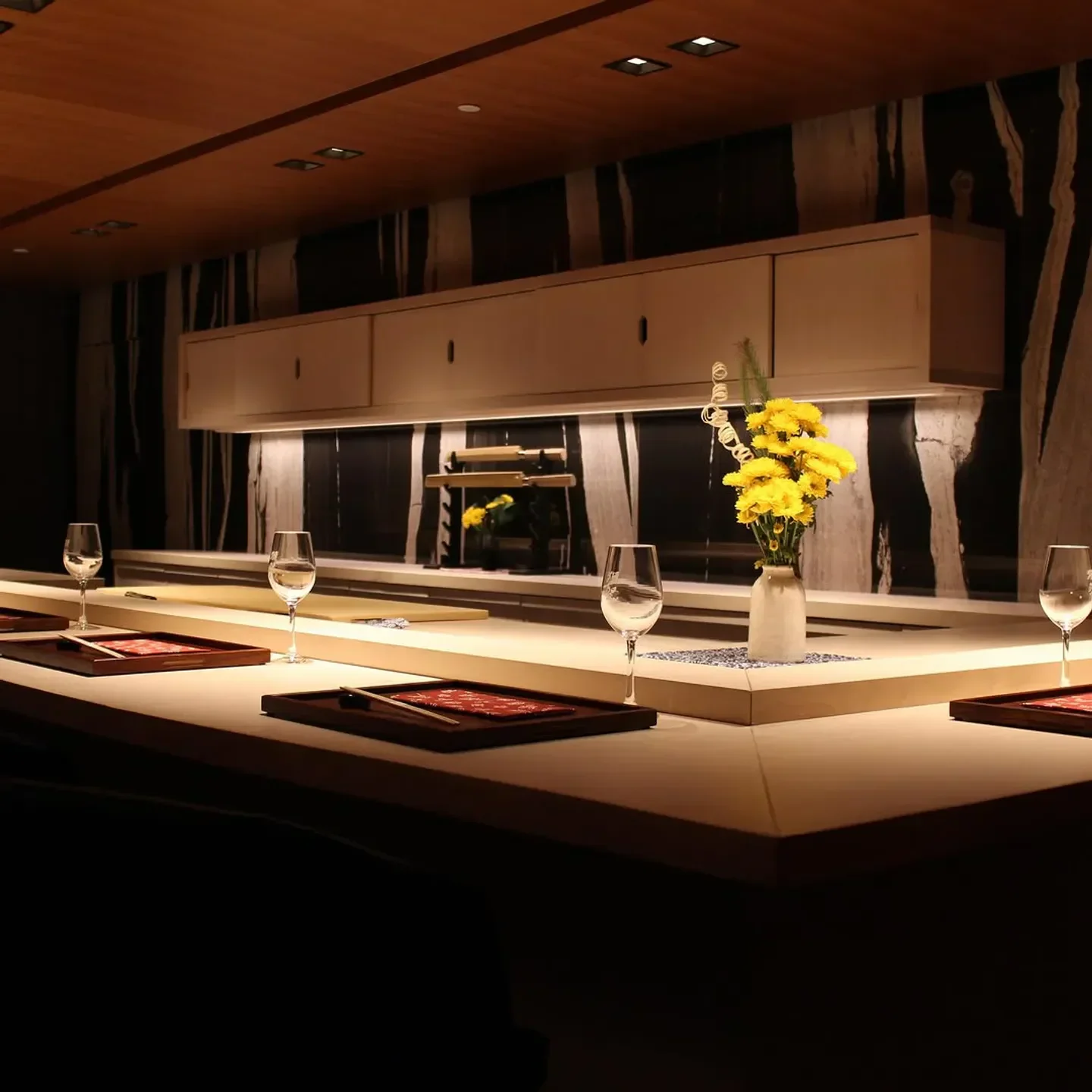 Elegant dining setting at Hayakawa, a stylish restaurant in Atlanta, featuring flower arrangement.