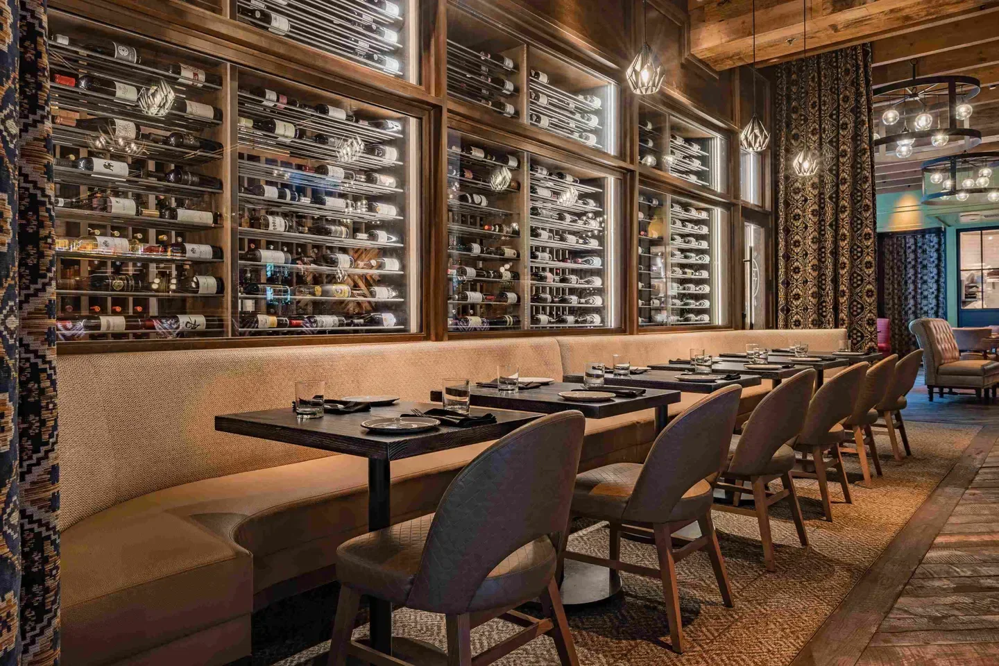 Interior of Haywire - Dallas restaurant with wine display and seating in Dallas.