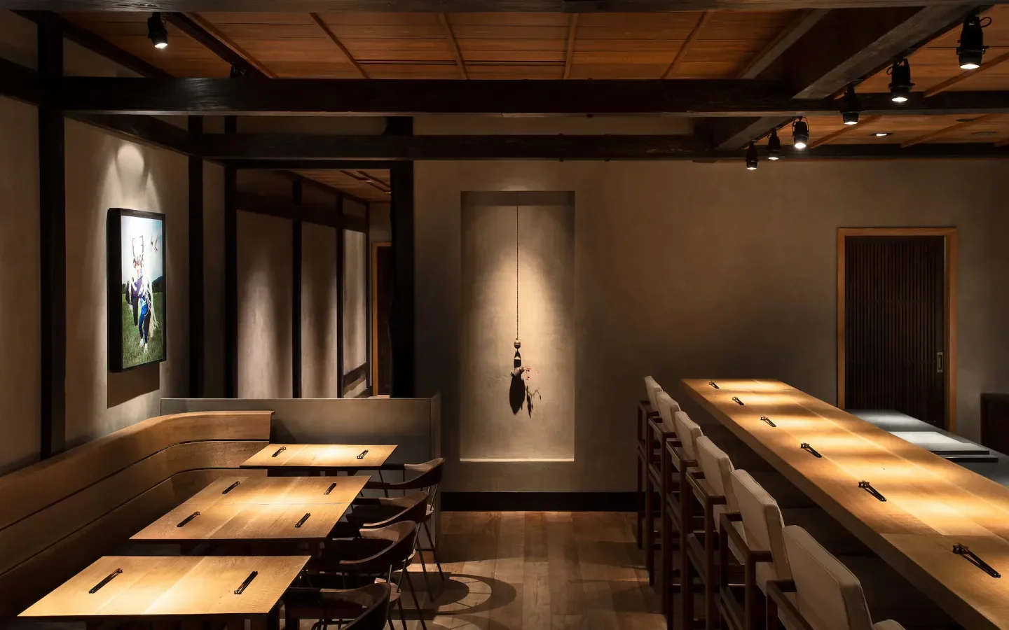 Elegant dining space at HIROKI in Philadelphia, featuring minimalist design and warm lighting.