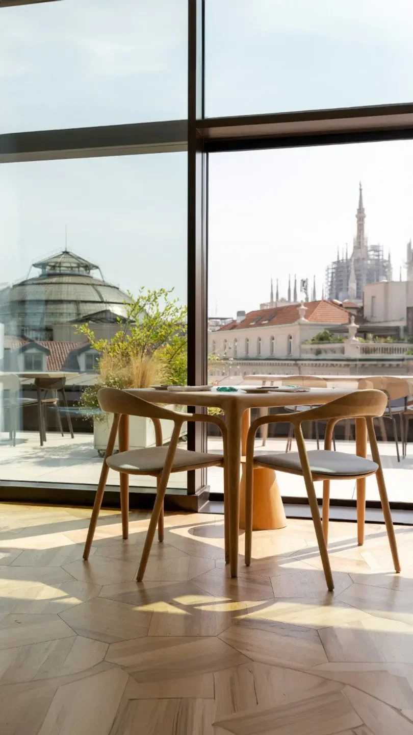 Horto restaurant in Milan with a view of the city's iconic architecture.
