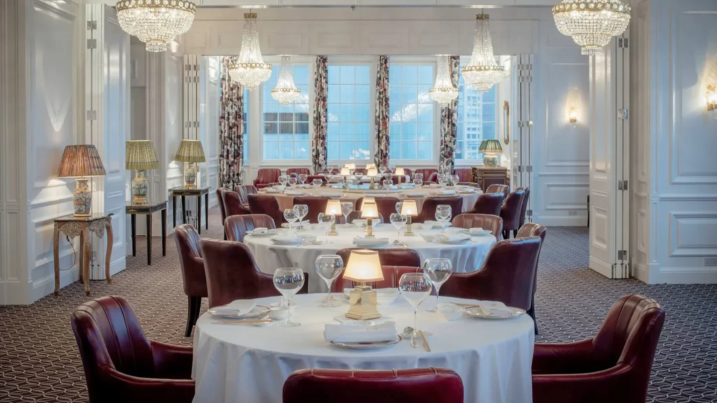 Elegant dining room at Howard's Gourmet restaurant in Hong Kong, with crystal chandeliers.
