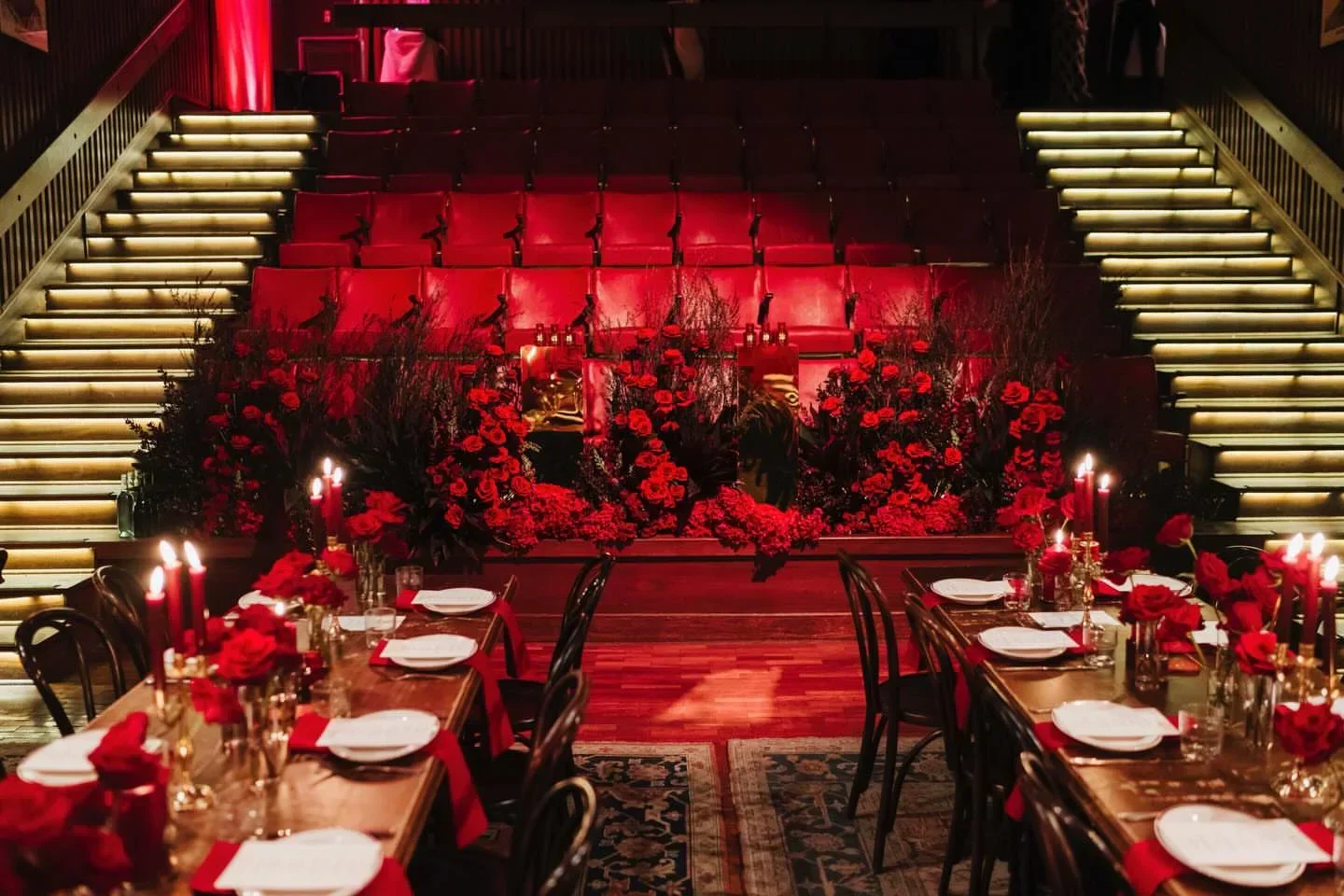Romantic candlelit dinner setting at Hubert restaurant in Sydney, with red roses and moody lighting