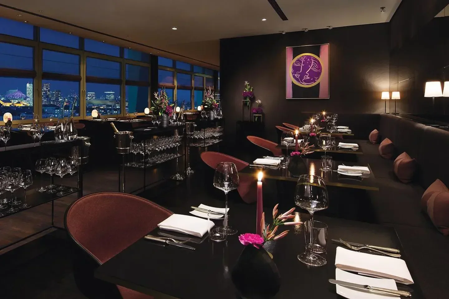 Elegant dining at Hugos Berlin restaurant with city views and romantic candlelight.