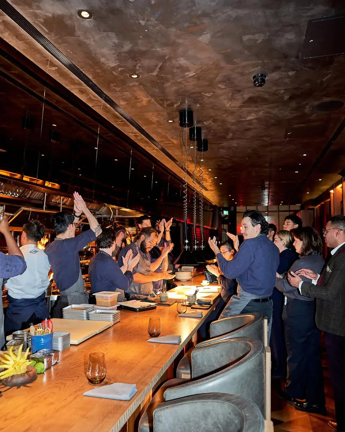 Chefs and staff at HUMO restaurant in London celebrate a successful service.