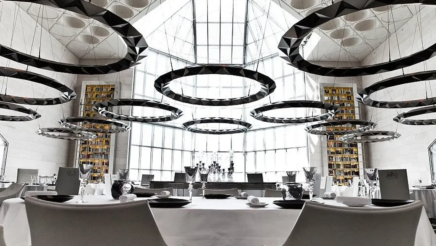 Idam By Alain, Doha: modern restaurant interior with geometric lighting and tables